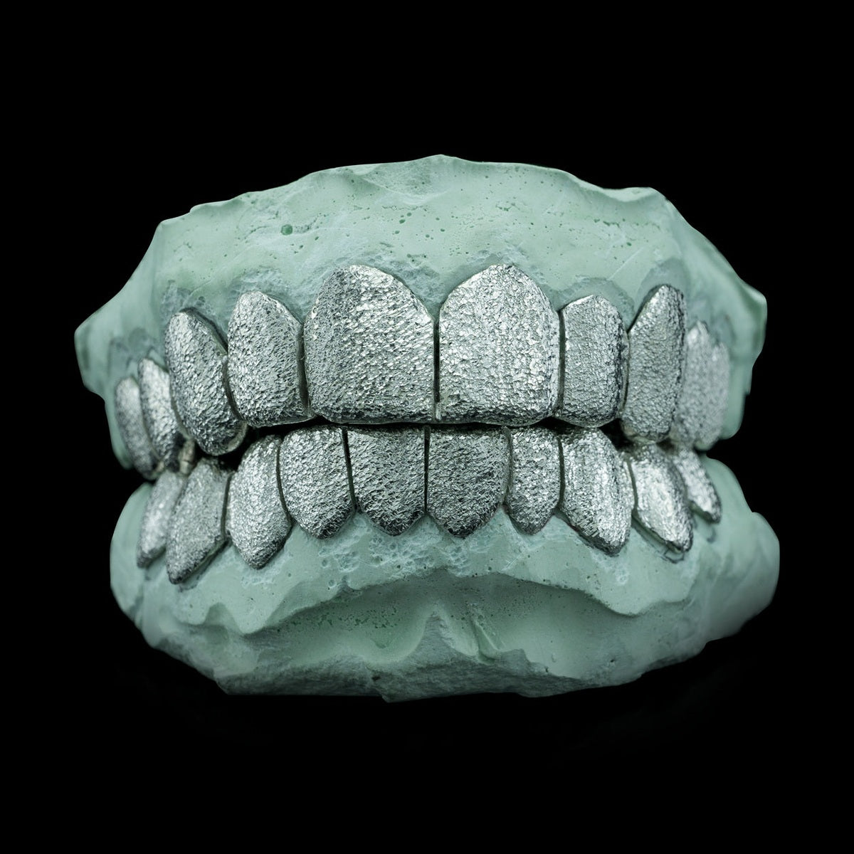 Custom fit .925 sterling silver diamond dust grillz with deep cut design on dental mold