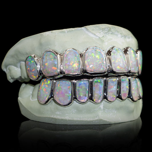 Opal grillz in display, featuring clear opal crystals on elegant metal backing