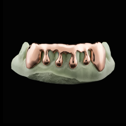 Rose gold grill on a green background