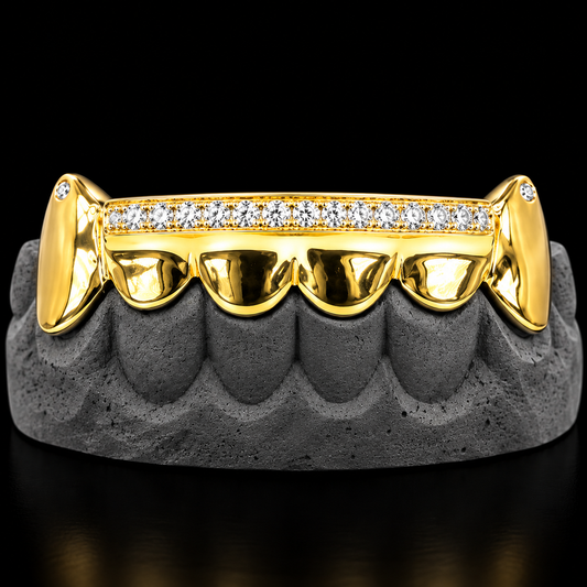 Front view of gold upper grillz featuring paved round diamonds and fang tips