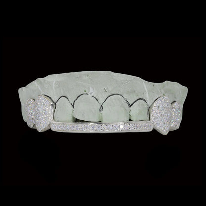 White gold diamond fang grillz with heart cutouts and channel-set lower bar on dental mold