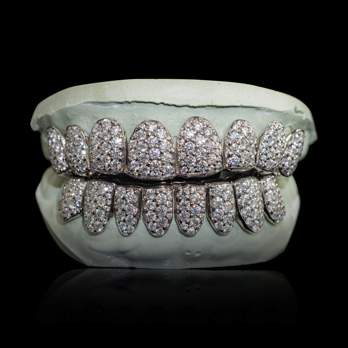 Sterling silver VVS moissanite grillz with large 2mm stones in honeycomb zigzag setting on dental mold
