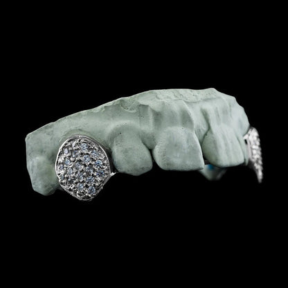Silver-tone scalloped edge top fang grillz with round-cut Moissanite stones