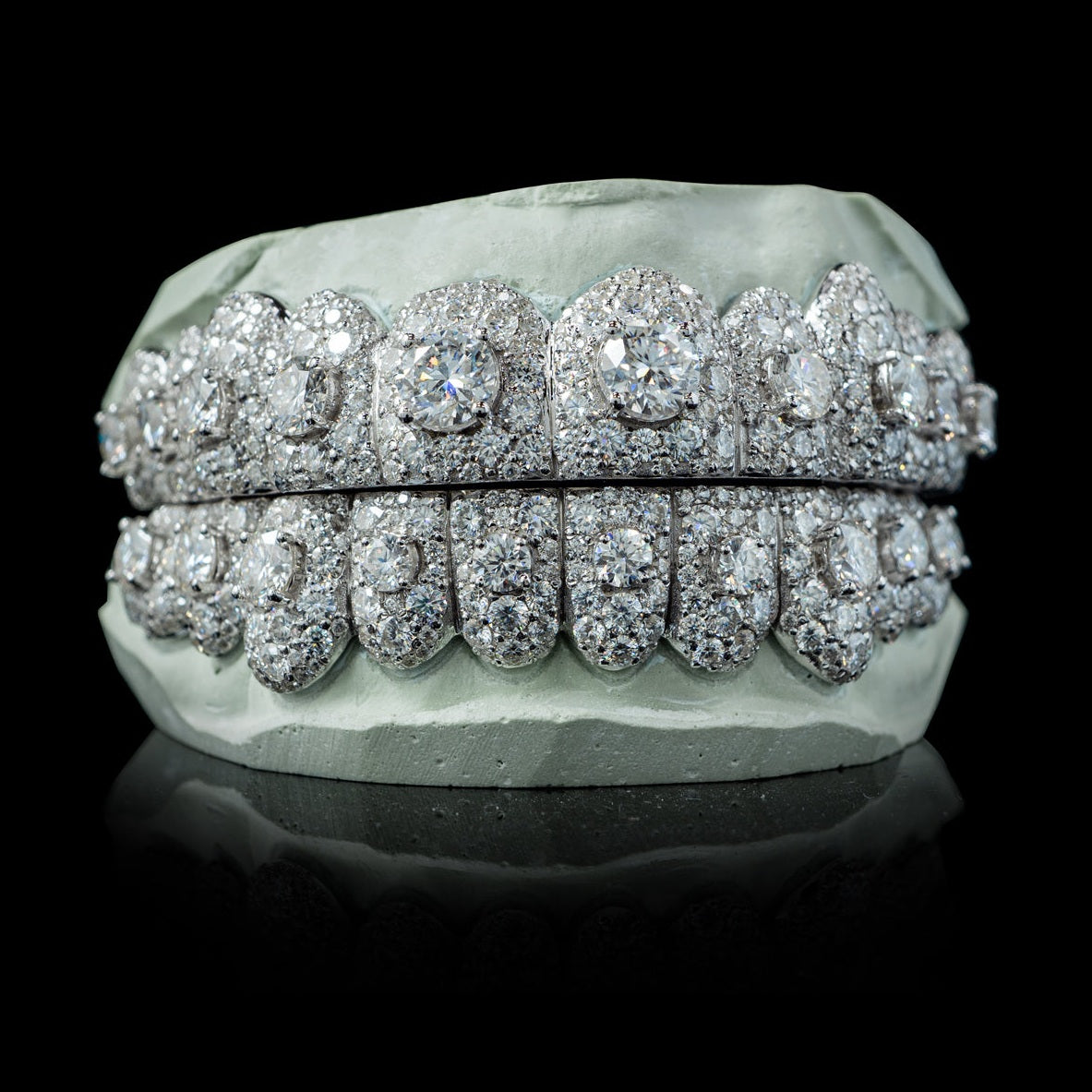 Full coverage white metal iced moissanite grillz showing depth and brilliant cut stones