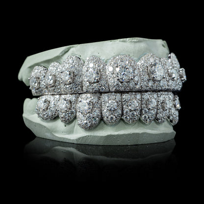 White gold moissanite grillz with dense pavé setting and large center stones on dental mold