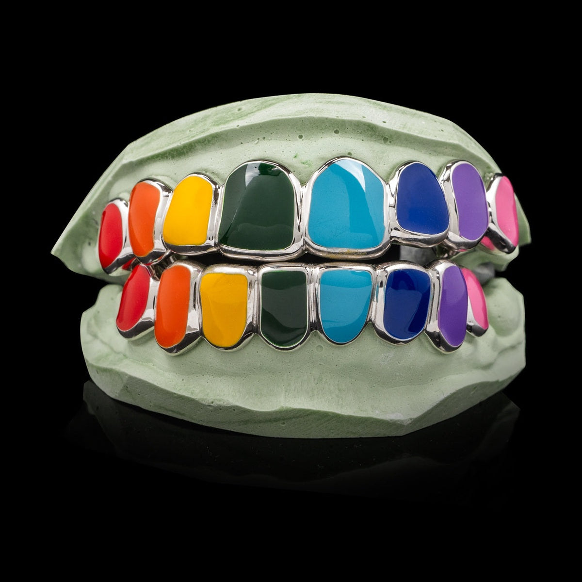 Rainbow enamel solid deep cut grillz on dental mold showing vibrant open-face teeth