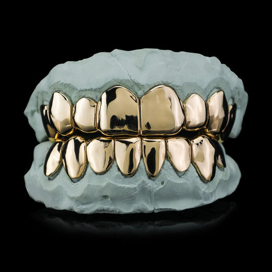 Yellow gold plated deep cut silver grillz on dental mold