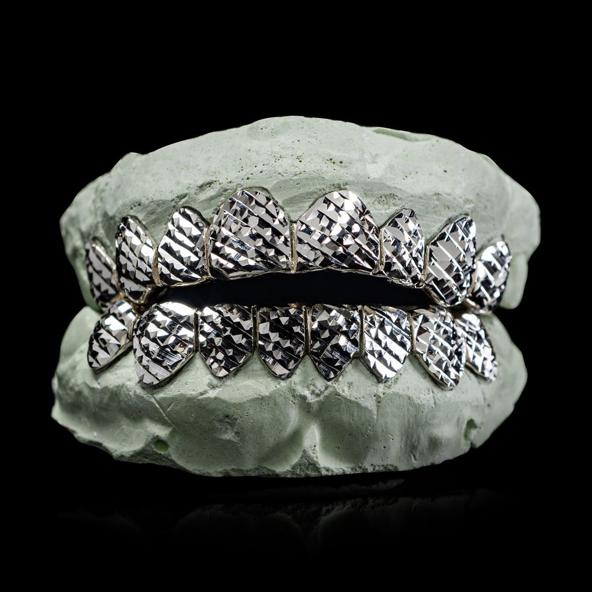 Solid .925 Sterling Silver diamond cut grillz with 8 top and bottom teeth on dental mold