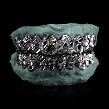 Silver nugget cut grillz featuring faceted diamond-cut pattern and angular grooves