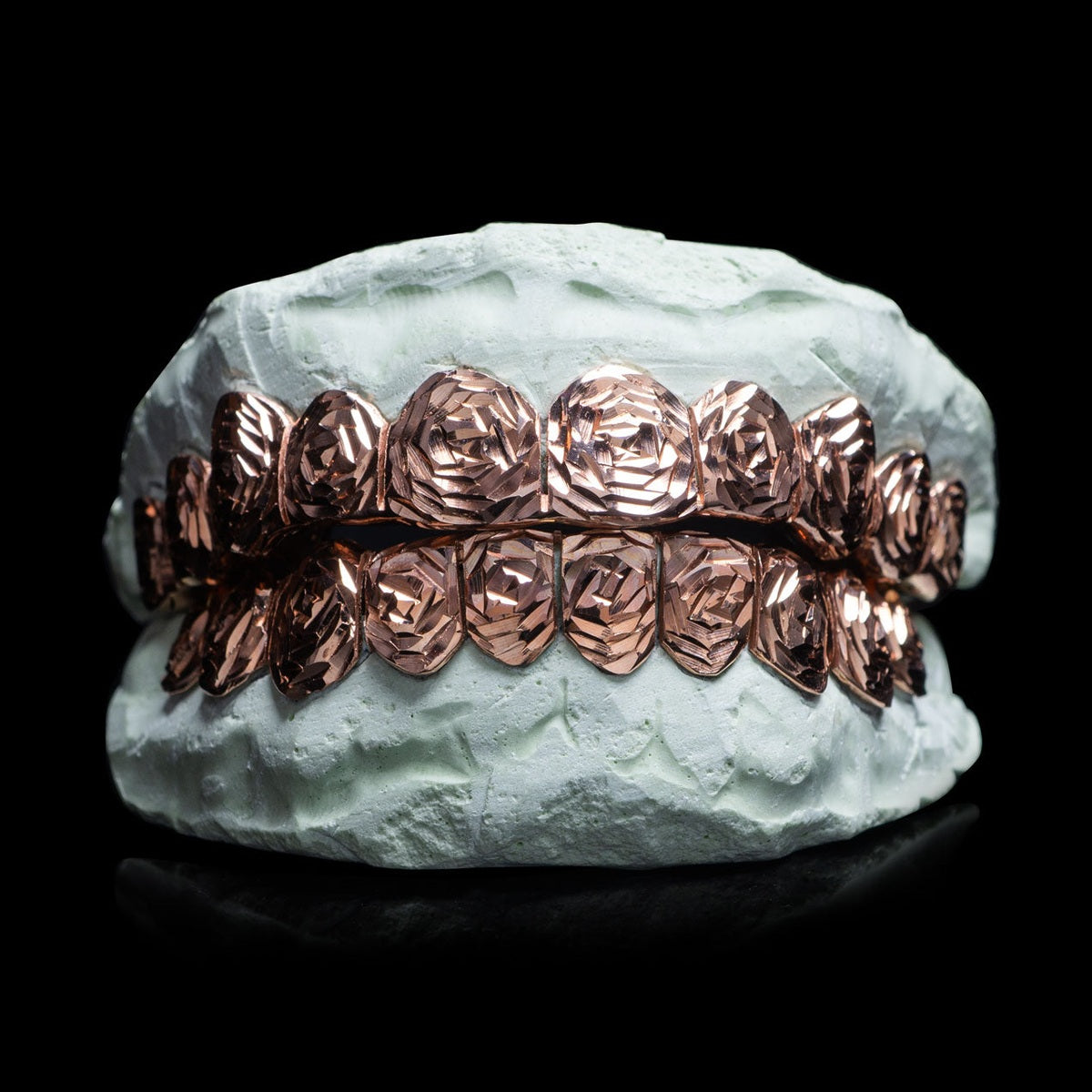 Rose cut silver grillz with rose gold finish on dental mold