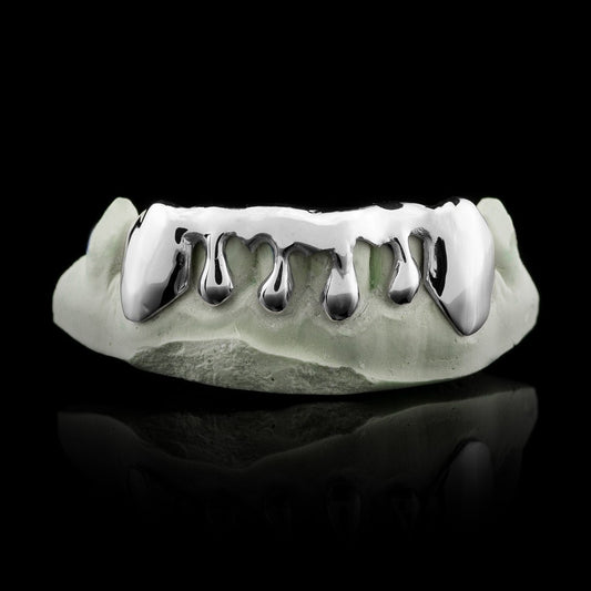 Solid sterling silver drip grillz with extended fangs and teardrop droplets on dental model