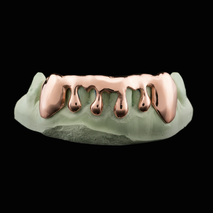 Rose gold grill on a green background