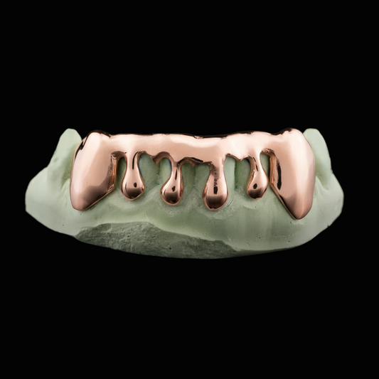 Rose gold grill on a green background