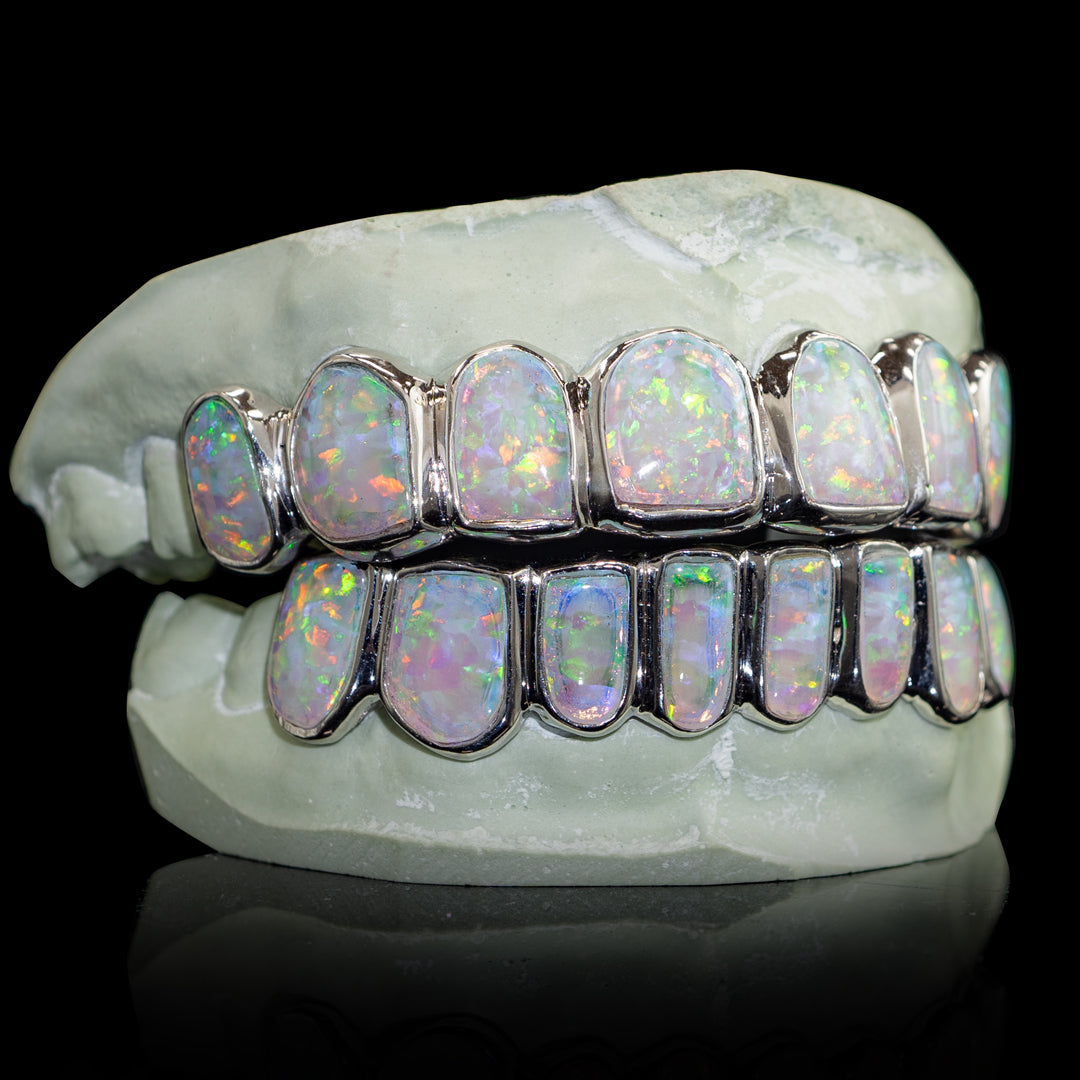 Opal grillz in display, featuring clear opal crystals on elegant metal backing
